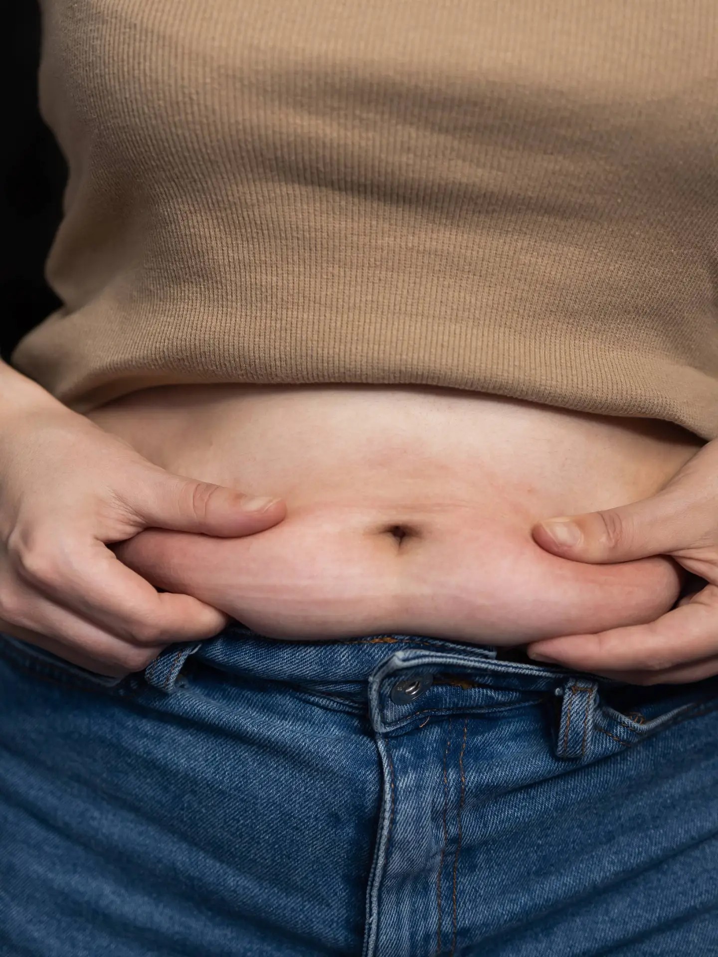woman-pinching-stomach-fat-2024-07-05-05-13-34-utc-1